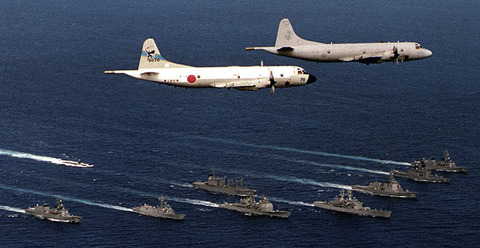 A U.S. Navy P-3 Orion from the Skinny Dragons of Patrol Squadron 4 leads a Japanese P-3 in flight over a Bilateral Force of U.S. and Japanese ships.  The ships in formation are; USS Key West(SSN 722), USS Vandergrift(FFG 48), USS California(CGN 36), USS Chancellorsville(CG 62),USS Port Royal(CG 73), JDS Kirishima(DDG 174), JDS Shirane(DDH 143), JDS Murasame(DD101), JDS Harusame(DD 102), and JDS Towada(AOE 422).  The operations are part of RIMPAC 98.